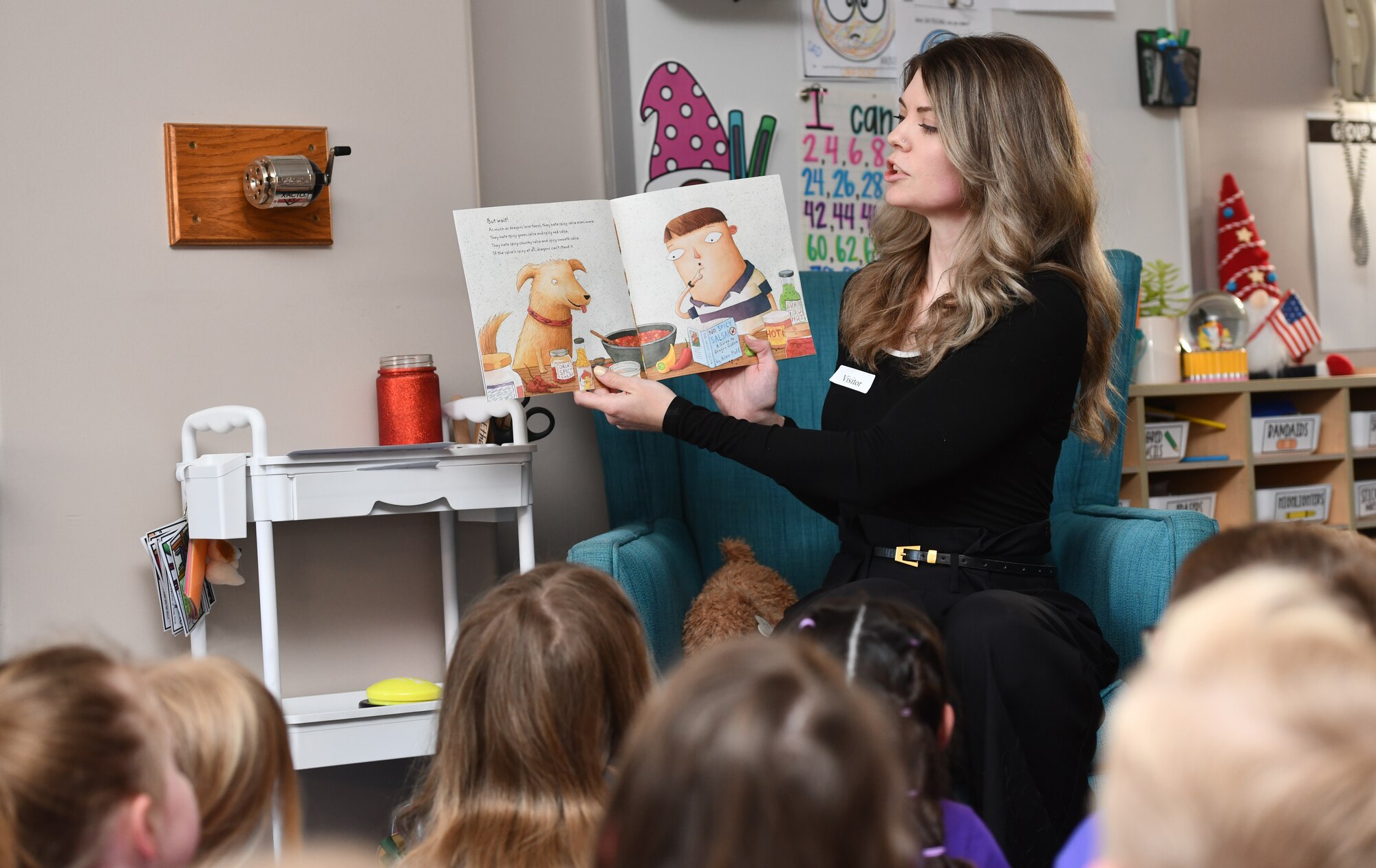 Joelle Mills, 55th Contracting Squadron contracting specialist, reads to Ms. Yurth's 2nd grade class at Patriot Elementary in La Vista, Nebraska, April 16, 2025. The event was part of the Month of the Military Child celebration, where service members read to school children. (U.S. Air Force photo by Chad Watkins)