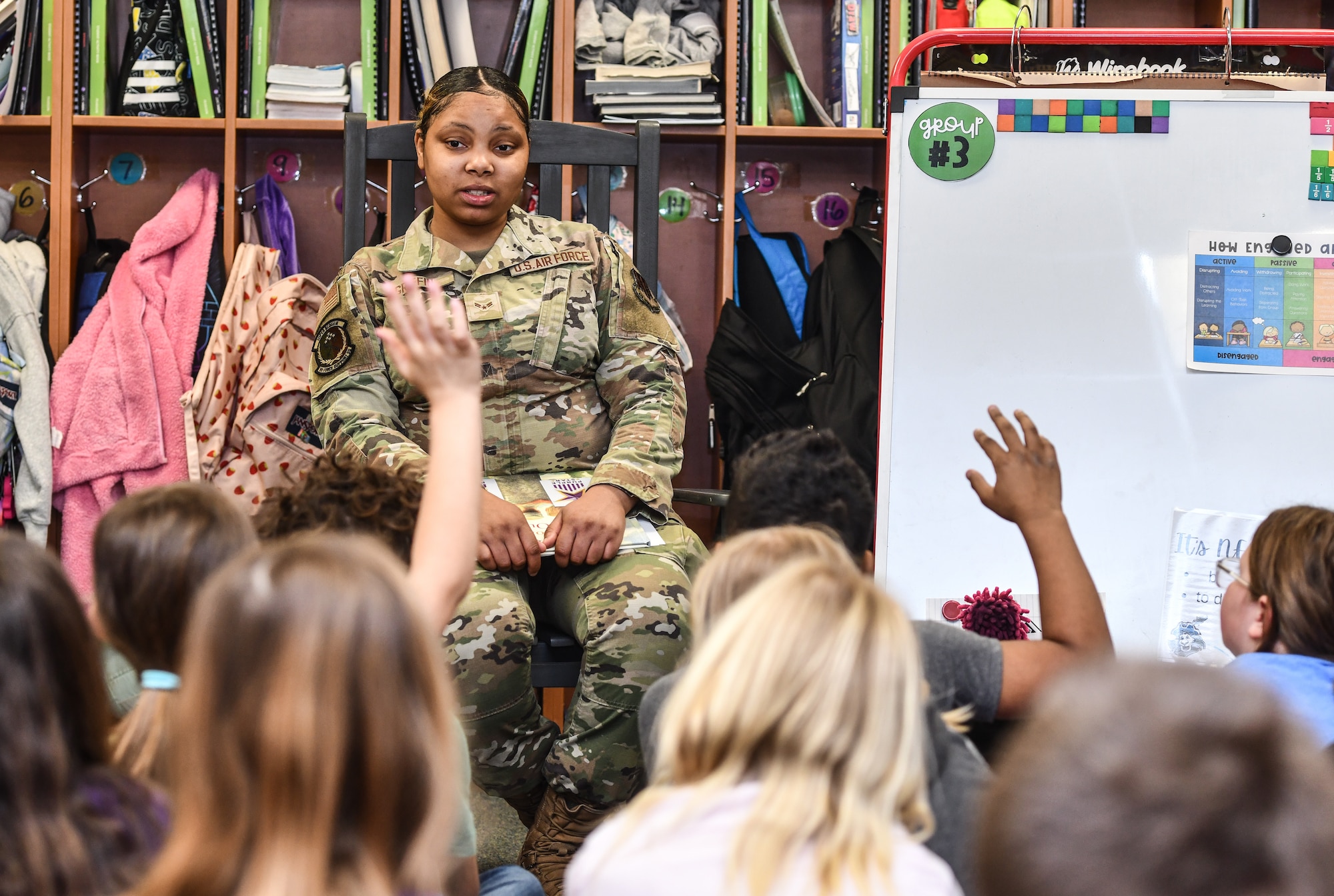 Airman 1st Class Diamond Griffin, 55th Force Support Squadron personnelist, reads to Ms. Inserra's 3rd grade class at Patriot Elementary in La Vista, Nebraska, April 16, 2025. The event was part of the Month of the Military Child celebration, where service members read to school children. (U.S. Air Force photo by Chad Watkins)
