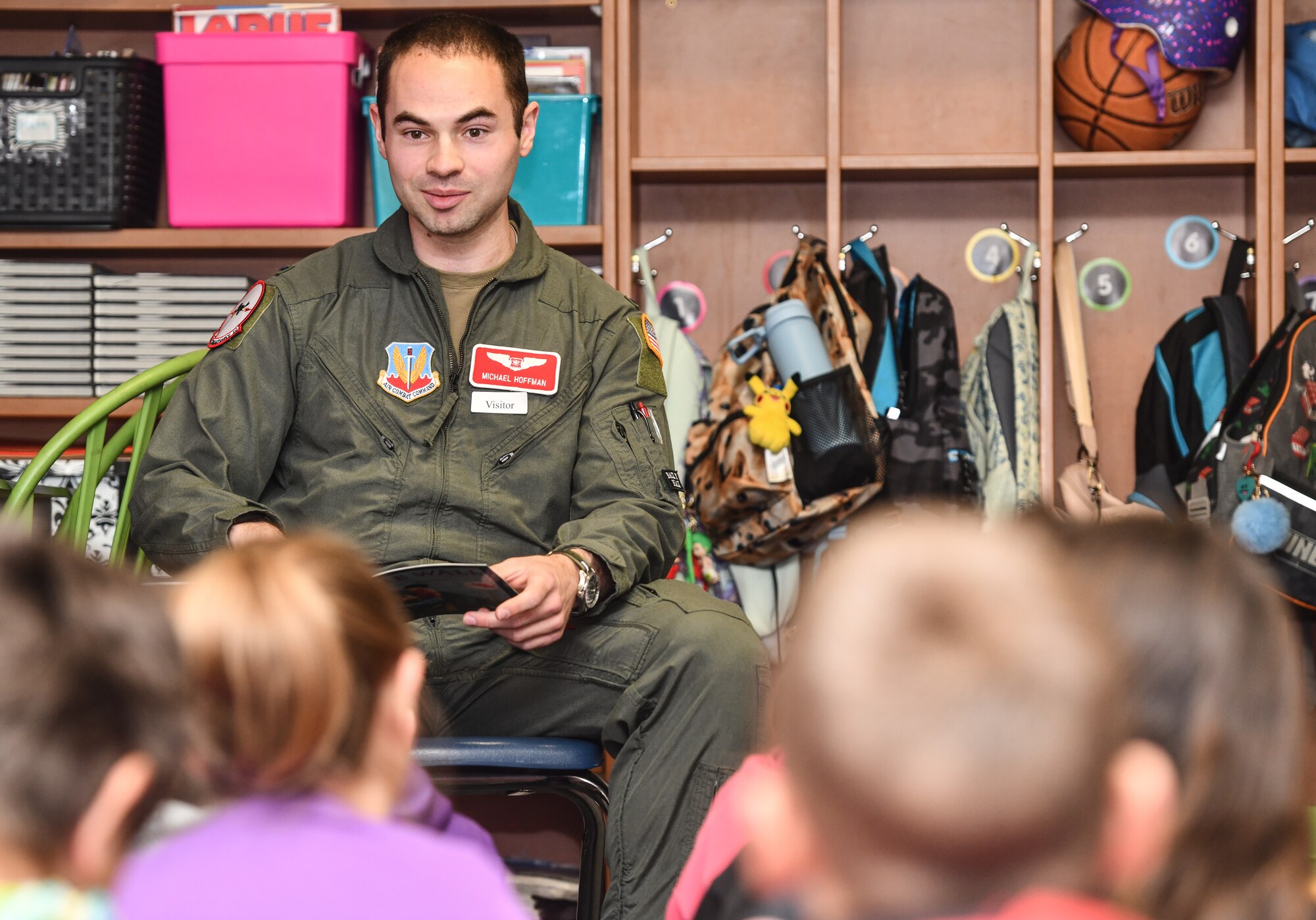1st Lt. Michael Hoffman, 343rd Reconnaissance Squadron navigator, reads to Ms. Collins' 3rd grade class at Patriot Elementary in La Vista, Nebraska, April 16, 2025. The event was part of the Month of the Military Child celebration, where service members read to school children. (U.S. Air Force photo by Chad Watkins)