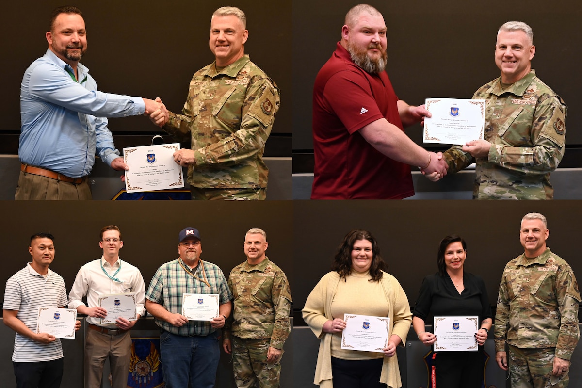 Men and women accepting an award certificate