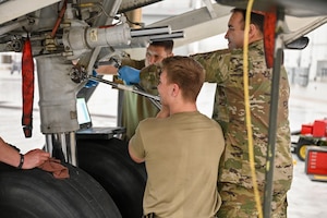 Senior Airman Hunter Shaw, 445th Aircraft Maintenance Squadron aircraft hydraulic specialist, uses a torque wrench, as his fellow aircraft hydraulic specialists Staff Sgt. Anthony Carreon and Tech. Sgt. Michael Lucero, hold the wrench and bolt in place on a C-17 Globemaster III at Wright-Patterson Air Force Base, March 16, 2025. The Airmen were re-assembling the front hydraulic strut of the C-17. A torque wrench is used to ensure fasteners like nuts and bolts are tighten to a specific, pre-determined torque value, which is crucial for safety, proper assembly, and performance of equipment. They prevent both overtightening and under tightening.