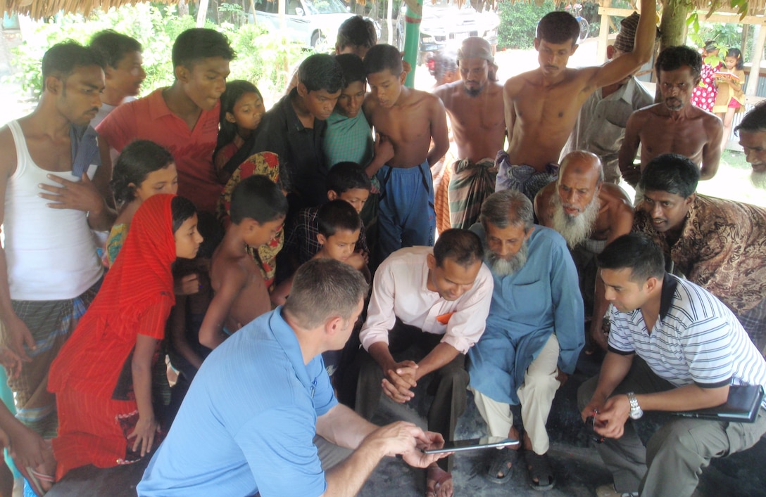 Stan Wharry, former chief of the district’s Asia Programs Office, converses with locals in Bangladesh during a preliminary site visit in 2010. Construction for the multipurpose disaster shelter program began that year and culminated in 2024 with the completion of the Khonjonighona Government Primary School and Multipurpose Disaster Shelter.