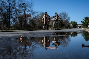 U.S. Air Force Tech. Sgt. Kenneth Maurer, 87th Explosive Ordnance Disposal section chief and Senior Airman Alexander Evans, 87th Explosive Ordnance Disposal team member walk to the water plant to safely disarm a fabricated ordnance during Operation Honey Badger (OHB) at Joint Base McGuire-Dix-Lakehurst, N.J., April 8, 2025. OHB is an exercise organized by the 87th Civil Engineer Squadron to prepare Airmen for real-world situations and promote mission readiness. (U.S. Air Force photo by Airman 1st Class Luisa E. Dugan)