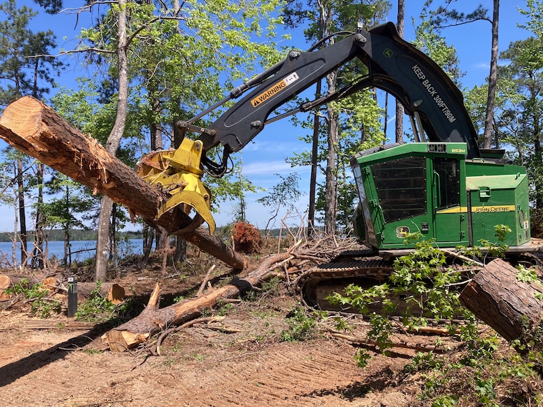 Photo of truck removing roots from a fallen tree.