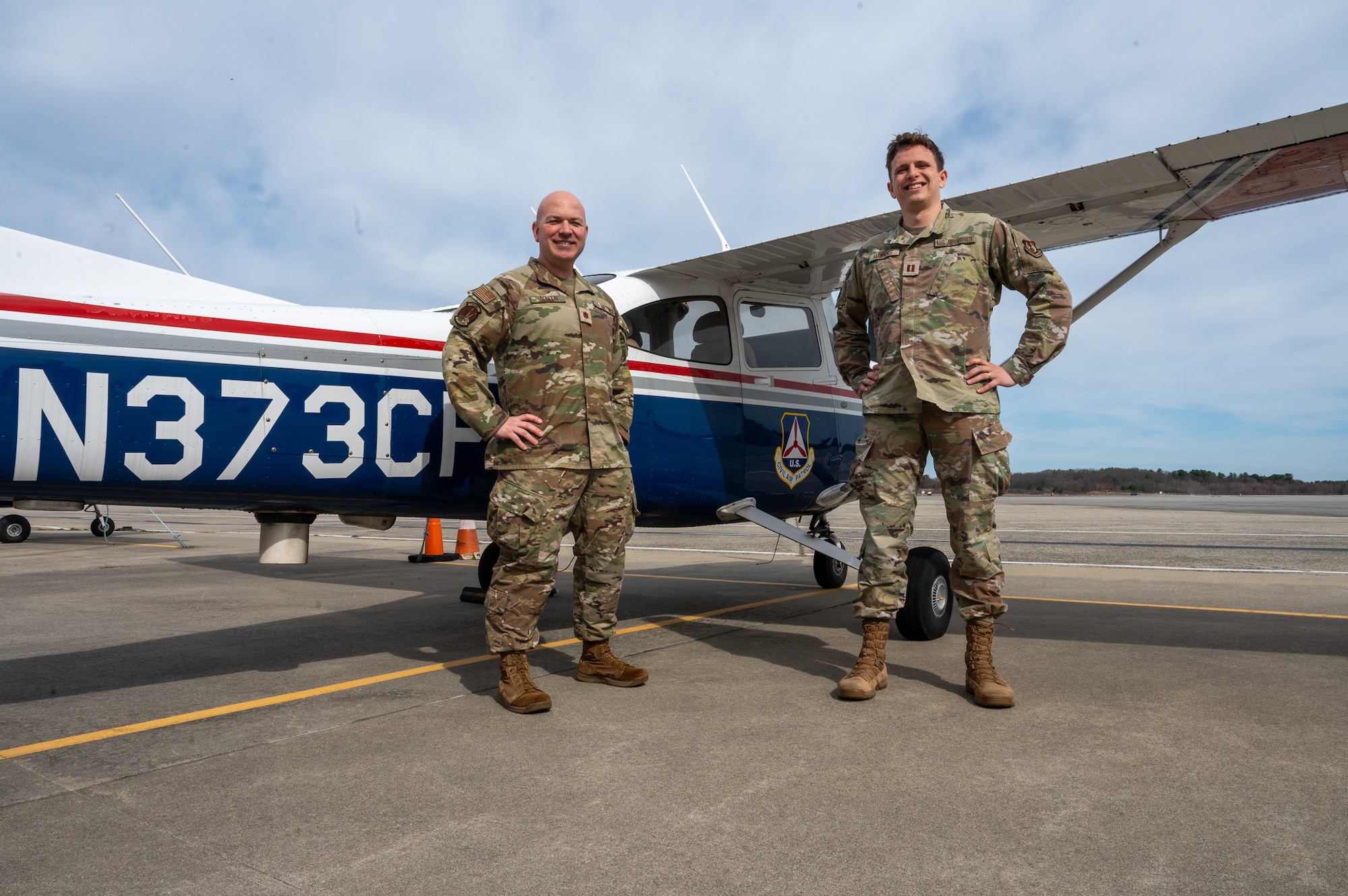 Image of two Airmen standing by Civil Air Patrol Aircraft.