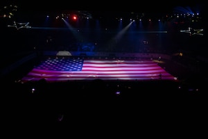 Military personnel display the U.S. Flag during the annual Military Appreciation Night at the Foster Communications Coliseum, San Angelo, Texas, April 16, 2025. The San Angelo Stock Show & Rodeo Association honored Goodfellow Air Force Base military members and personnel at the annual Military Appreciation Night to show their support towards military members for protecting the rights and freedoms of the nation. (U.S. Air Force photo by Airman 1st Class Brian Lummus)
