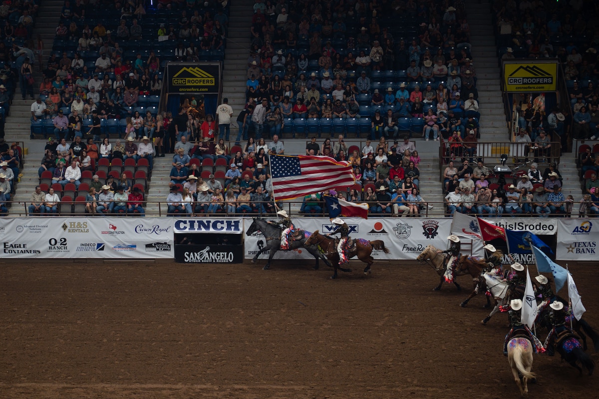 San Angelo Stock Show and Rodeo Ambassadors carry the U.S., Texas, and U.S. military service branch flags at the San Angelo Stock Show & Rodeo at Foster Communications Coliseum in San Angelo, Texas, April 16, 2025. The Ambassadors carried the flags as part of the opening ceremony of Military Appreciation Night. (U.S. Air Force photo by Airman 1st Class Brian Lummus)