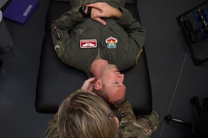 U.S. Air Force Capt. Michelle Jilek, 633rd Medical Operations Squadron physical therapist, examines Maj. Seth Rumbarger, 71st Fighter Squadron T-38 Talon pilot.