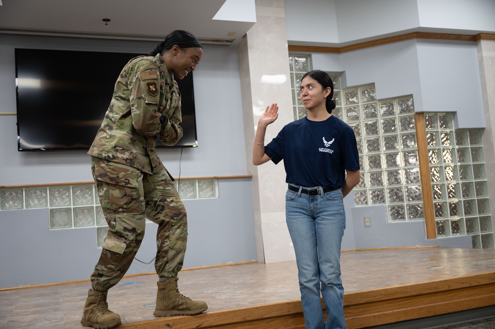 An Airman smiles at a future Air Force Trainee during a development and training session here at Barksdale Air Force Base.