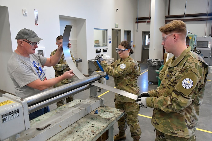 (From left) Darrel Gronau, aviation maintenance instructor, teaches metal forming and tool safety to ROTC Utah Military Academy students Cole Duffield, Alexandra Hyde and Max Richins March 11, 2025, at Hill Air Force Base, Utah. Local students learn, train and develop real-world airframe work skills by participating in local academic partnerships with the Hill Aerospace Museum’s established curriculum at the aircraft restoration facility. (U.S. Air Force photo by Todd Cromar)