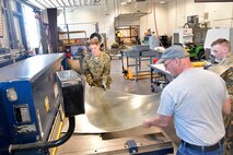 (From left) Max Richins, ROTC Utah Military Academy, Darrell Gronau, aviation maintenance instructor, and Cole Duffield, ROTC Utah Military Academy, cut sheet metal for replacement fuselage skin March 11, 2025, at Hill Air Force Base, Utah. Local students learn, train and develop real-world airframe work skills by participating in local academic partnerships with the Hill Aerospace Museum’s established curriculum at the aircraft restoration facility. (U.S. Air Force photo by Todd Cromar)