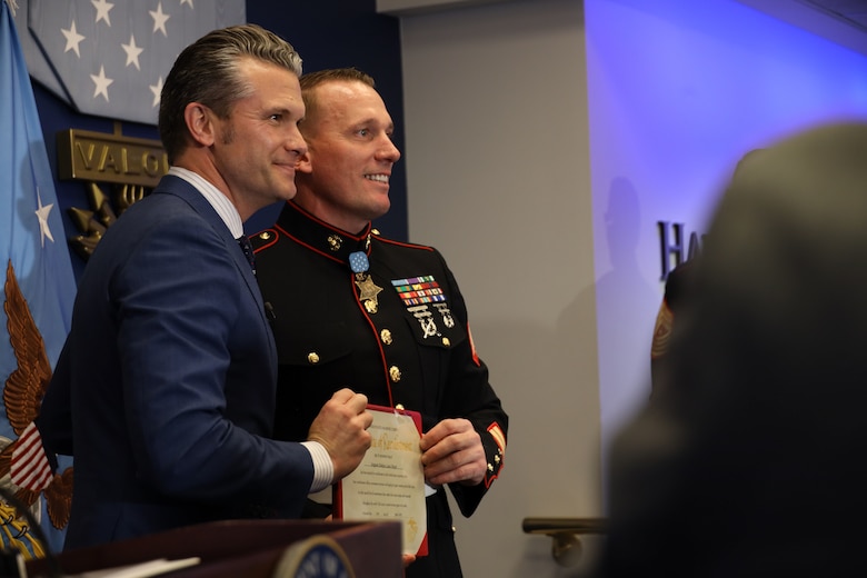 U.S. Marine Corps Sgt. Dakota Meyer, a Medal of Honor recipient, stands with Pete Hegseth, the Secretary of Defense, after reenlisting in a ceremony at the Pentagon, April 17, 2025. Sgt. Meyer is the only living Medal of Honor recipient currently serving in the Marine Corps. (U.S. Marine Corps photos by Lance Cpl. Abigail Hutcheson)