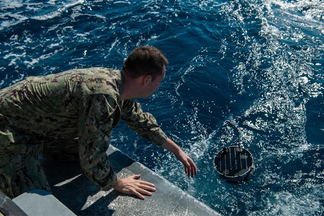 Solder lowers a floating sensor that collects maritime environmental data.
