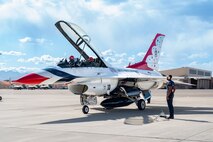 From Left to right, U.S. Air Force Lt. Col. Taylor Wight, an operations officer and pilot assigned to the Thunderbirds, and Michael Patterson, a Hometown Hero participant and passenger, settle into their seats while Staff Sgt. William Solomon, #8 assistant dedicated crew chief assigned to the Thunderbirds, is waits to perform a preflight check on April 4, 2025 at Nellis Air Force Base, Nevada.