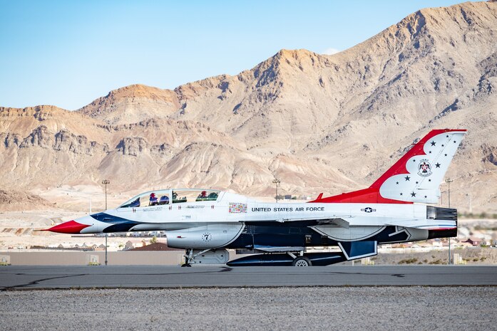 U.S. Air Force Lt. Col. Taylor Wight, left, an operations officer assigned to the Thunderbirds, and Michael Patterson, a Hometown Hero participant, prepare for take-off on April 4, 2025, at Nellis Air Force Base, Nevada.