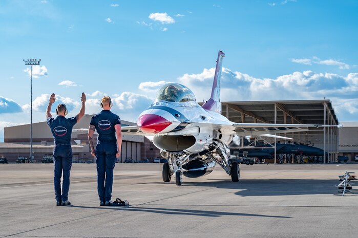 U.S. Air Force dedicated crew chiefs assigned to the Thunderbirds, marshal an F-16 returning back from a Hometown Hero flight on April 4, 2025 at Nellis Air Force Base, Nevada.