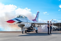 U.S. Air Force dedicated crew chiefs assigned to the USAF Air Demonstration Squadron Thunderbirds, hold jet step ladders while waiting for an F-16 returning back from a Hometown Hero flight to come to a complete stop on April 4, 2025, at Nellis Air Force Base, Nevada.