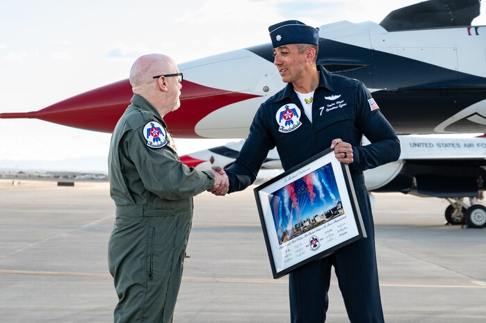 U.S. Air Force Lt. Col. Taylor Wight, right, an operations officer assigned to the Thunderbirds, presents Hometown Hero participant, Michael Patterson, with a memorabilia on April 4, 2025 at Nellis Air Force Base, Nevada.