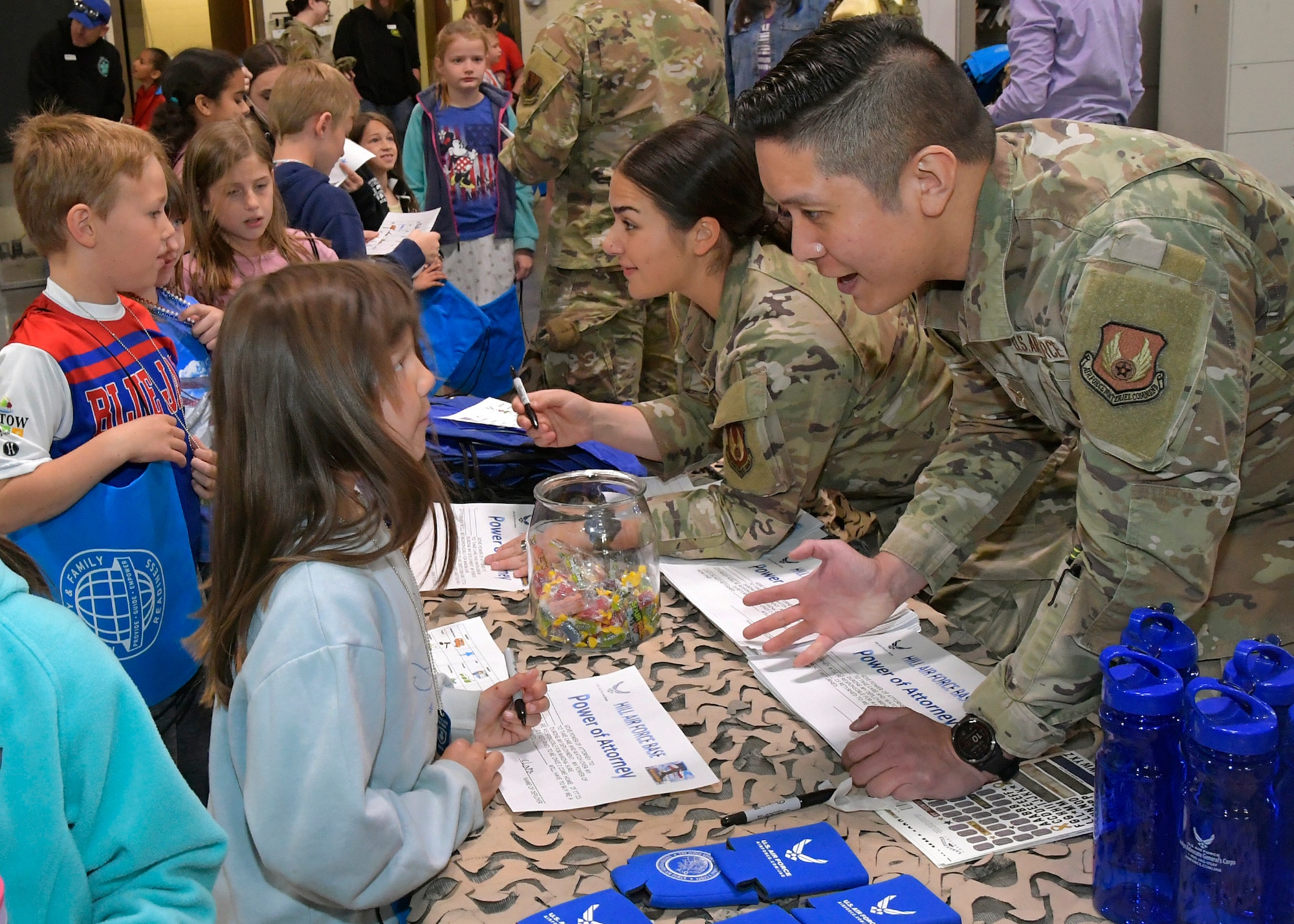 Airmen interact with students in a mock deployment line.