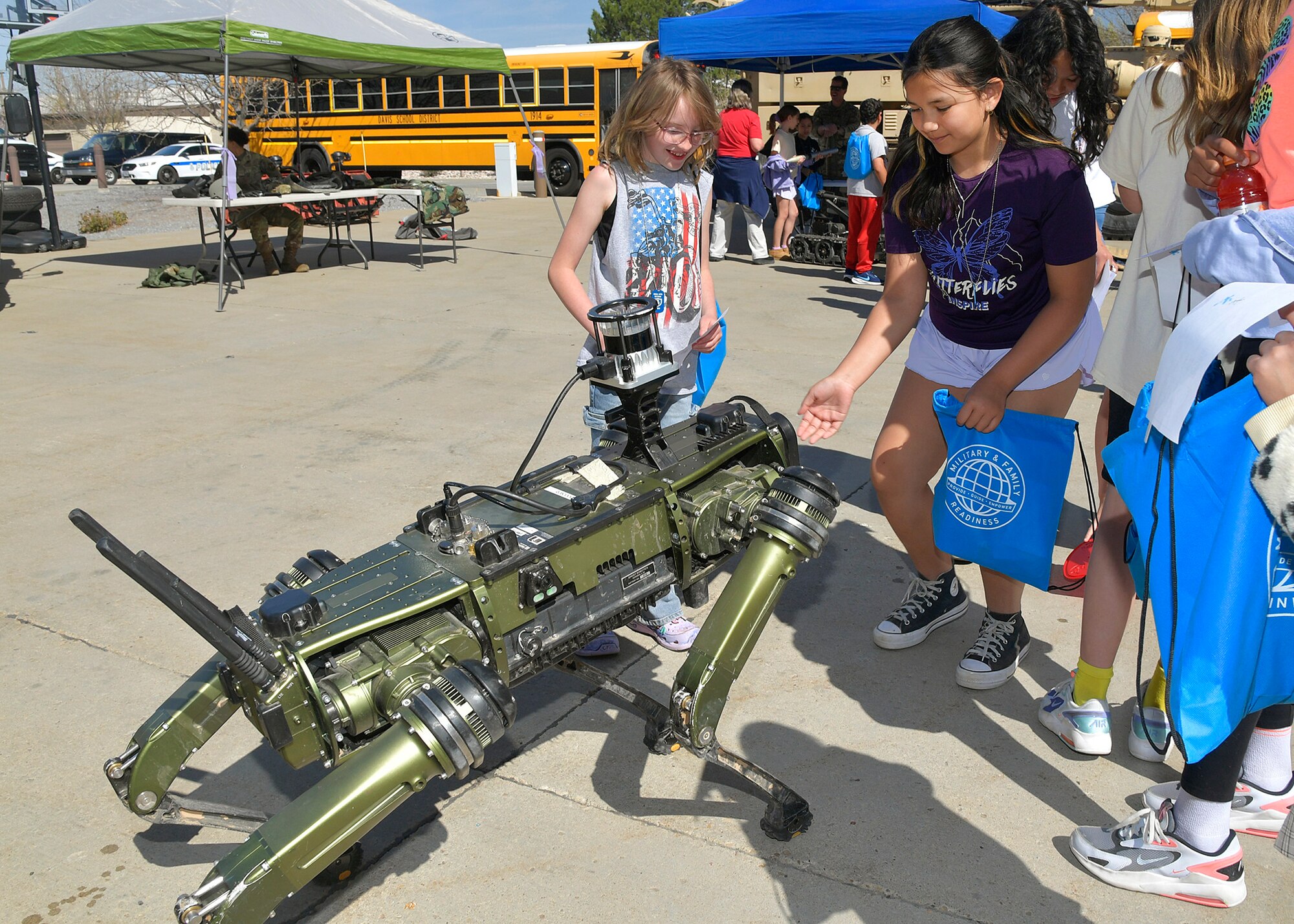 Students interact with a robotic dog.