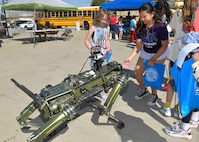 Students interact with a robotic dog.