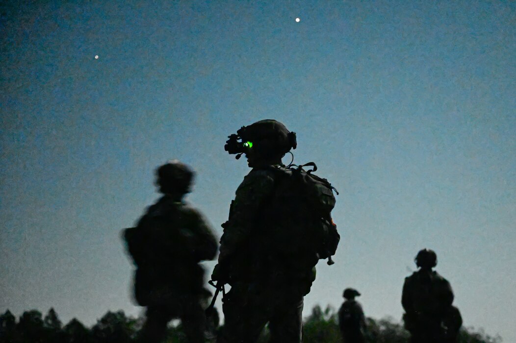 Explosive ordnance disposal (EOD) technicians and 19th Medical Group personnel secure the area during a joint EOD field training exercise at Camp Joseph T. Robinson, Arkansas, April 9, 2025. The exercise brought together more than 20 technicians from Barksdale, Fairchild and Hill Air Force bases. In a key partnership, medical personnel from the 19th Medical Group also embedded with the EOD teams to provide critical care during simulated operations.