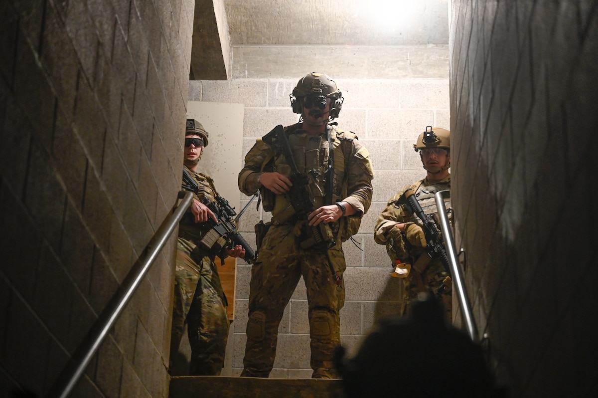 Explosive ordnance disposal (EOD) technicians and 19th Medical Group personnel secure a building during a joint EOD field training exercise at Camp Joseph T. Robinson, Arkansas, April 9, 2025. The teams operated using live explosives, allowing EOD technicians to run full mission profiles from start to finish with realistic stressors and outcomes.