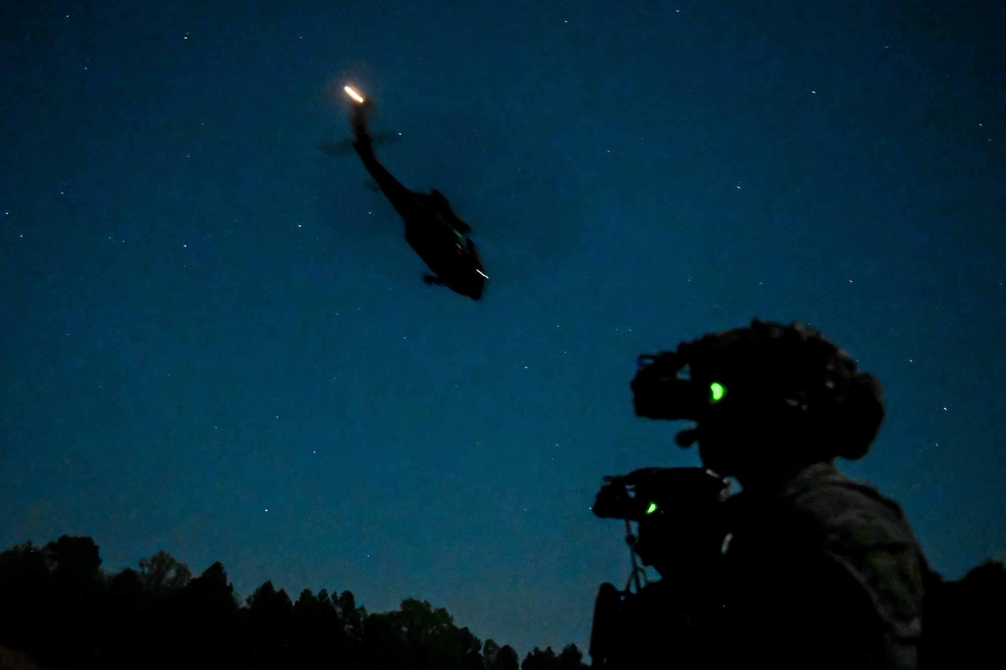 Explosive ordnance disposal (EOD) technicians and 19th Medical Group personnel guard the perimeter during a joint EOD field training exercise at Camp Joseph T. Robinson, Arkansas, April 9, 2025. The exercise brought together more than 20 technicians from Barksdale, Fairchild and Hill Air Force bases. In a key partnership, medical personnel from the 19th Medical Group also embedded with the EOD teams to provide critical care during simulated operations.