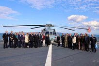 Sailors, officials, dignitaries and guests pose for a group photo during a key leadership engagement between the United States and Tunisia aboard the Blue Ridge-class command and control ship USS Mount Whitney (LCC 20) April 17, 2025.