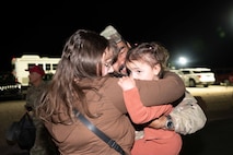 U.S. Air Force Senior Airman Payton Cobb, assigned to the 820th Rapid Engineering Deployable Heavy Operations Repair Squadron Engineer Squadron, reunites with his family during a redeployment at Nellis Air Force Base, Nevada, April 2, 2025