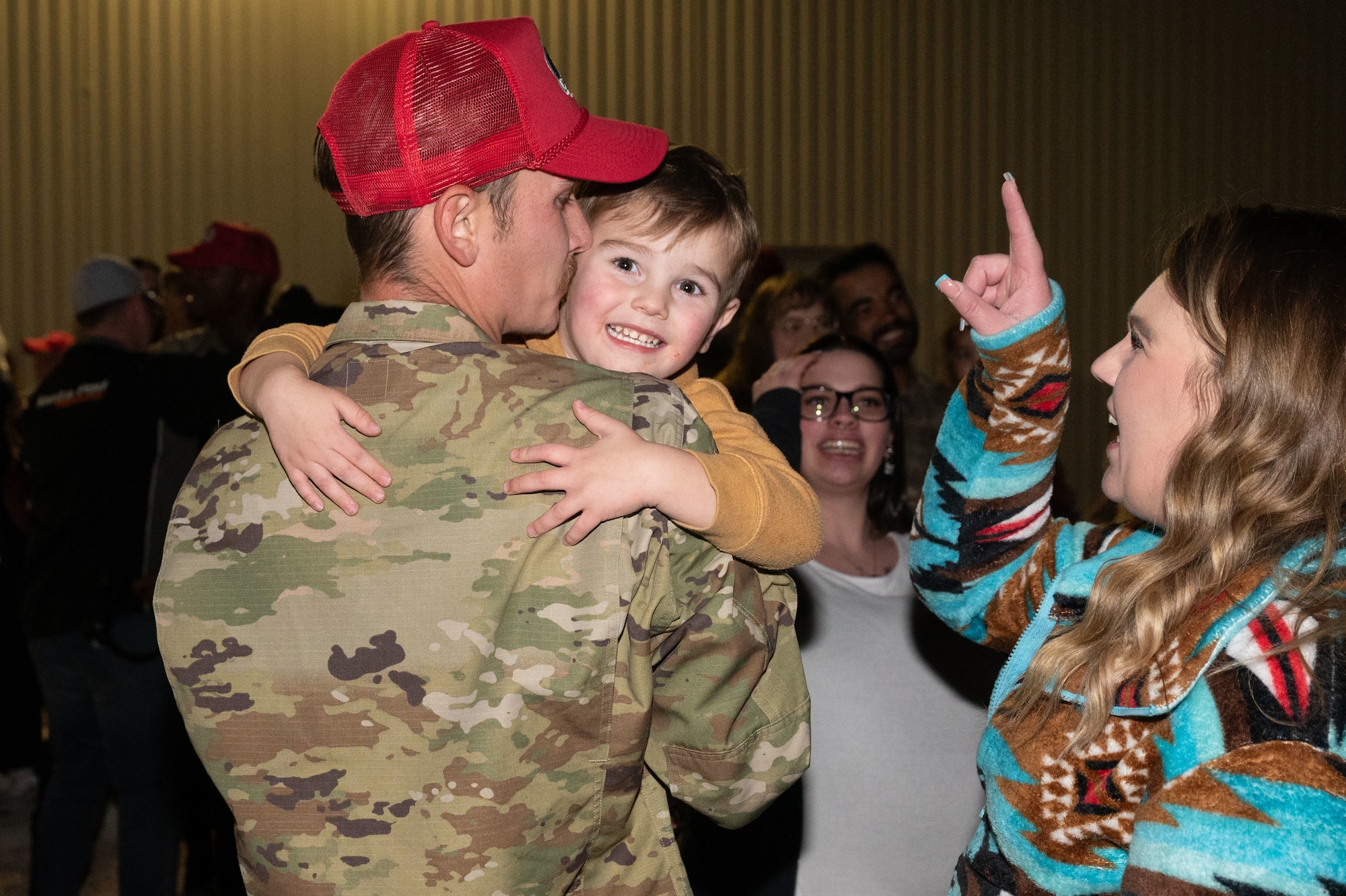U.S. Air Force Senior Airman David Nelson, assigned to the 820th Rapid Engineering Deployable Heavy Operations Repair Squadron Engineer Squadron, reunites with his family during a redeployment at Nellis Air Force Base (AFB), Nevada, April 2, 2025.