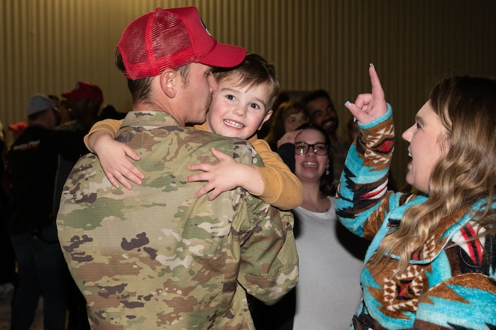 U.S. Air Force Senior Airman David Nelson, assigned to the 820th Rapid Engineering Deployable Heavy Operations Repair Squadron Engineer Squadron, reunites with his family during a redeployment at Nellis Air Force Base (AFB), Nevada, April 2, 2025.