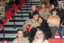 U.S. Air Force Airmen assigned to the 820th and 555th Rapid Engineering Deployable Heavy Operations Repair Squadron Engineer Squadrons sit with their loved ones during a redeployment debrief at Nellis Air Force Base, Nevada, April 2, 2025.