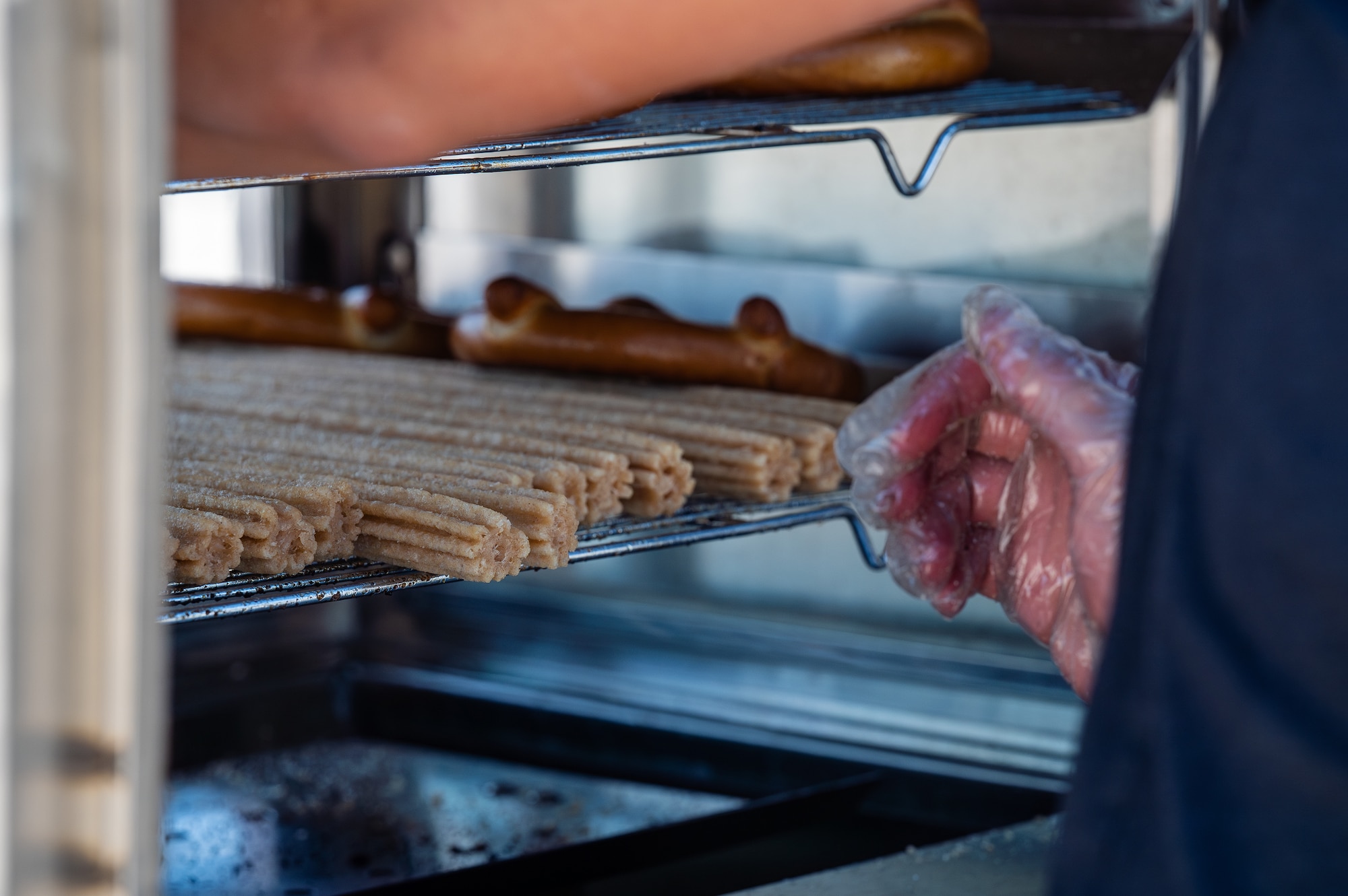 A churro and pretzel vendor tends to their stand during Aviation Nation 2025 at Nellis Air Force Base, Nevada, April 4, 2025.