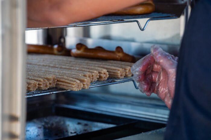 A churro and pretzel vendor tends to their stand during Aviation Nation 2025 at Nellis Air Force Base, Nevada, April 4, 2025.