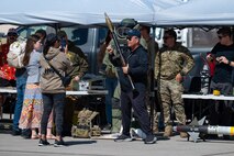 Attendees of Aviation Nation 2025 interact with military equipment at Nellis Air Force Base, Nevada, April 5, 2025.