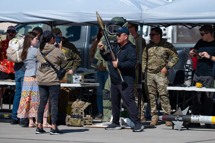 Attendees of Aviation Nation 2025 interact with military equipment at Nellis Air Force Base, Nevada, April 5, 2025.