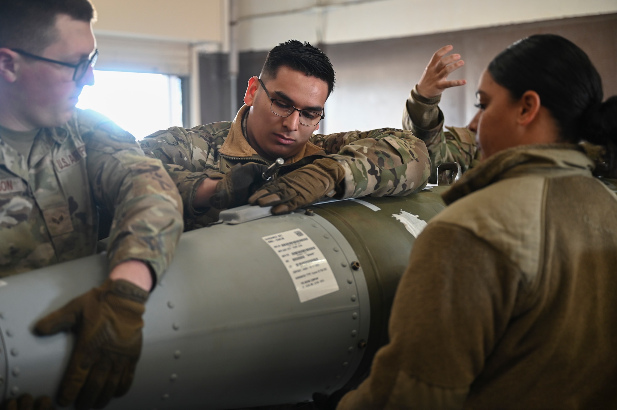 Senior Airman Diego Nava, 8th Maintenance Squadron Munitions Flight munitions support equipment maintenance crew chief, practices installing mounting equipment on a training munition during a combat munitions training.
