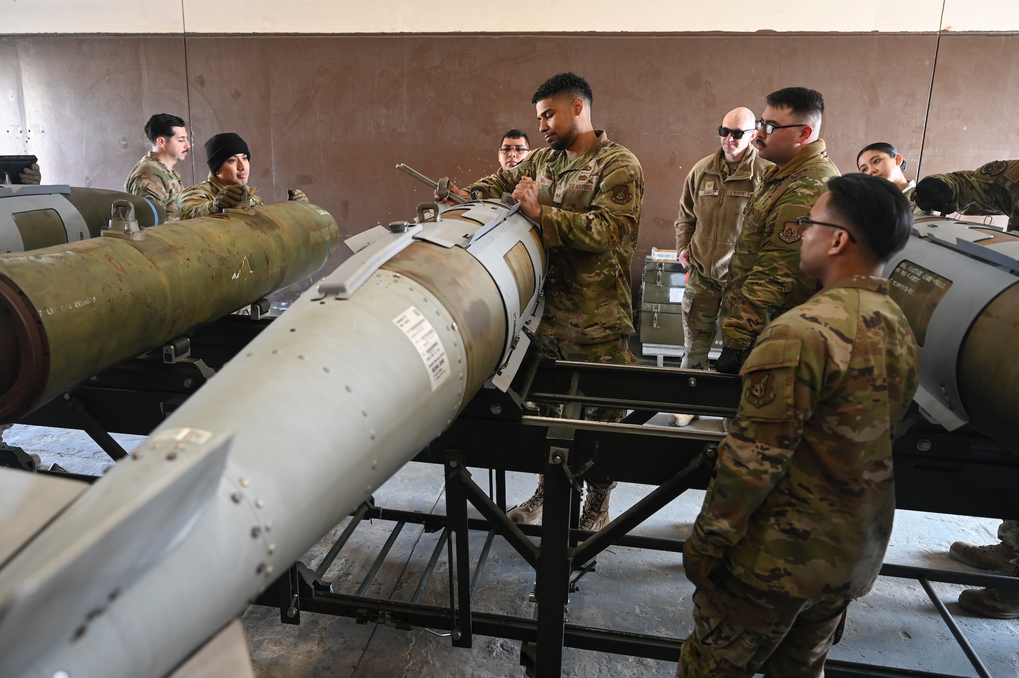 Airmen from the 8th Maintenance Squadron Munitions Flight complete combat munitions training on a training munition.