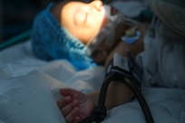 U.S. Air Force members from the Lesser Antilles Medical Assistant Team and Georgetown Public Hospital healthcare professionals at the Georgetown Public Hospital examine a two-month-old patient under anesthesia before receiving eye surgery in Georgetown, Guyana, April 7, 2025.