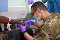 U.S. Air Force Tech. Sgt. Edward Park, 433rd Aeromedical Staging Squadron medical technician, performs intravenous therapy on a patient inside the emergency room at the West Demerara Regional Hospital during the Lesser Antilles Medical Assistance Team mission in Georgetown, Guyana, April 8, 2025.