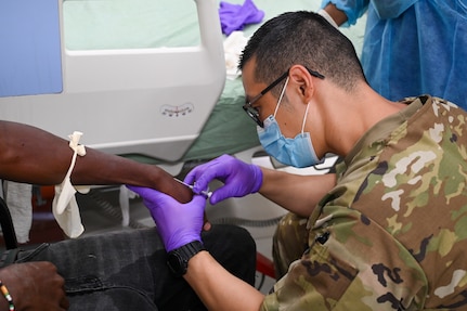 U.S. Air Force Tech. Sgt. Edward Park, 433rd Aeromedical Staging Squadron medical technician, performs intravenous therapy on a patient inside the emergency room at the West Demerara Regional Hospital during the Lesser Antilles Medical Assistance Team mission in Georgetown, Guyana, April 8, 2025.