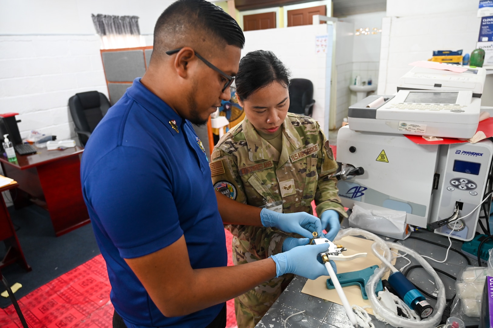 U.S. Air Force Senior Airman Liezel Westmoreland, 433rd Aeromedical Staging Squadron biomedical equipment technician, and Kumar Persaud, Ministry of Health biomedical technician assemble a cryotherapy gun at the West Demerara Regional Hospital during the Lesser Antilles Medical Assistance Team mission in Georgetown, Guyana, April 8, 2025.