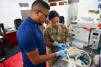 U.S. Air Force Senior Airman Liezel Westmoreland, 433rd Aeromedical Staging Squadron biomedical equipment technician, and Kumar Persaud, Ministry of Health biomedical technician assemble a cryotherapy gun at the West Demerara Regional Hospital during the Lesser Antilles Medical Assistance Team mission in Georgetown, Guyana, April 8, 2025.
