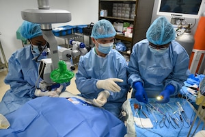 U.S. Air Force Maj. Samuel Hobbs, 59th Medical Wing vitreoretinal surgeon, works with local healthcare professionals during ophthalmology surgery at the Georgetown Public Hospital, Georgetown, Guyana, April 7, 2025 during the Lesser Antilles Medical Assistance Team 2025 mission.