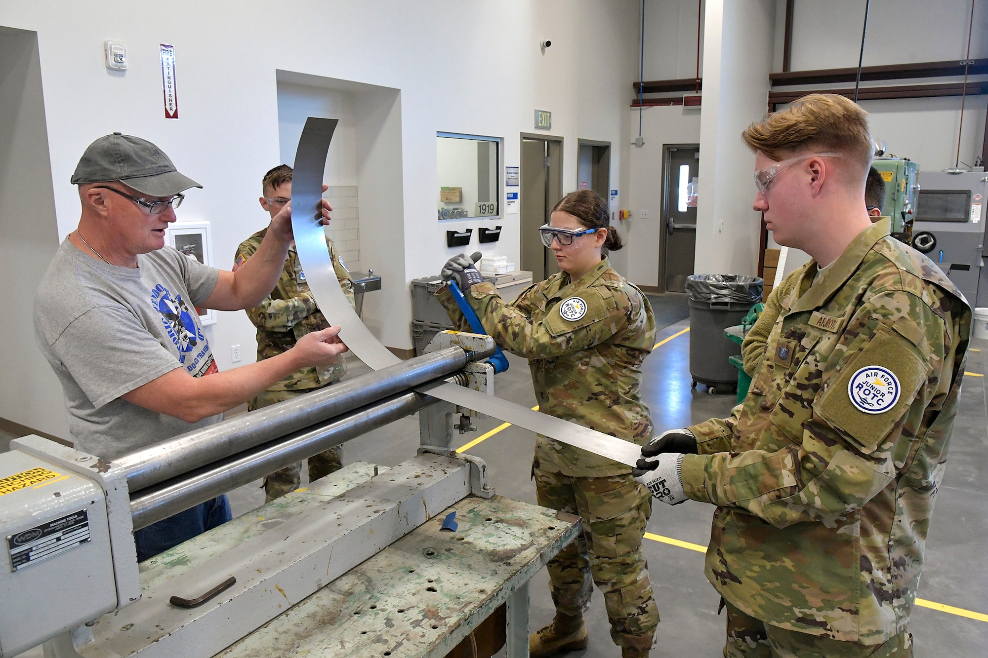 (From left) Darrel Gronau, aviation maintenance instructor, teaches metal forming and tool safety to ROTC Utah Military Academy students Cole Duffield, Alexandra Hyde and Max Richins March 11, 2025, at Hill Air Force Base, Utah. Local students learn, train and develop real-world airframe work skills by participating in local academic partnerships with the Hill Aerospace Museum’s established curriculum at the aircraft restoration facility. (U.S. Air Force photo by Todd Cromar)