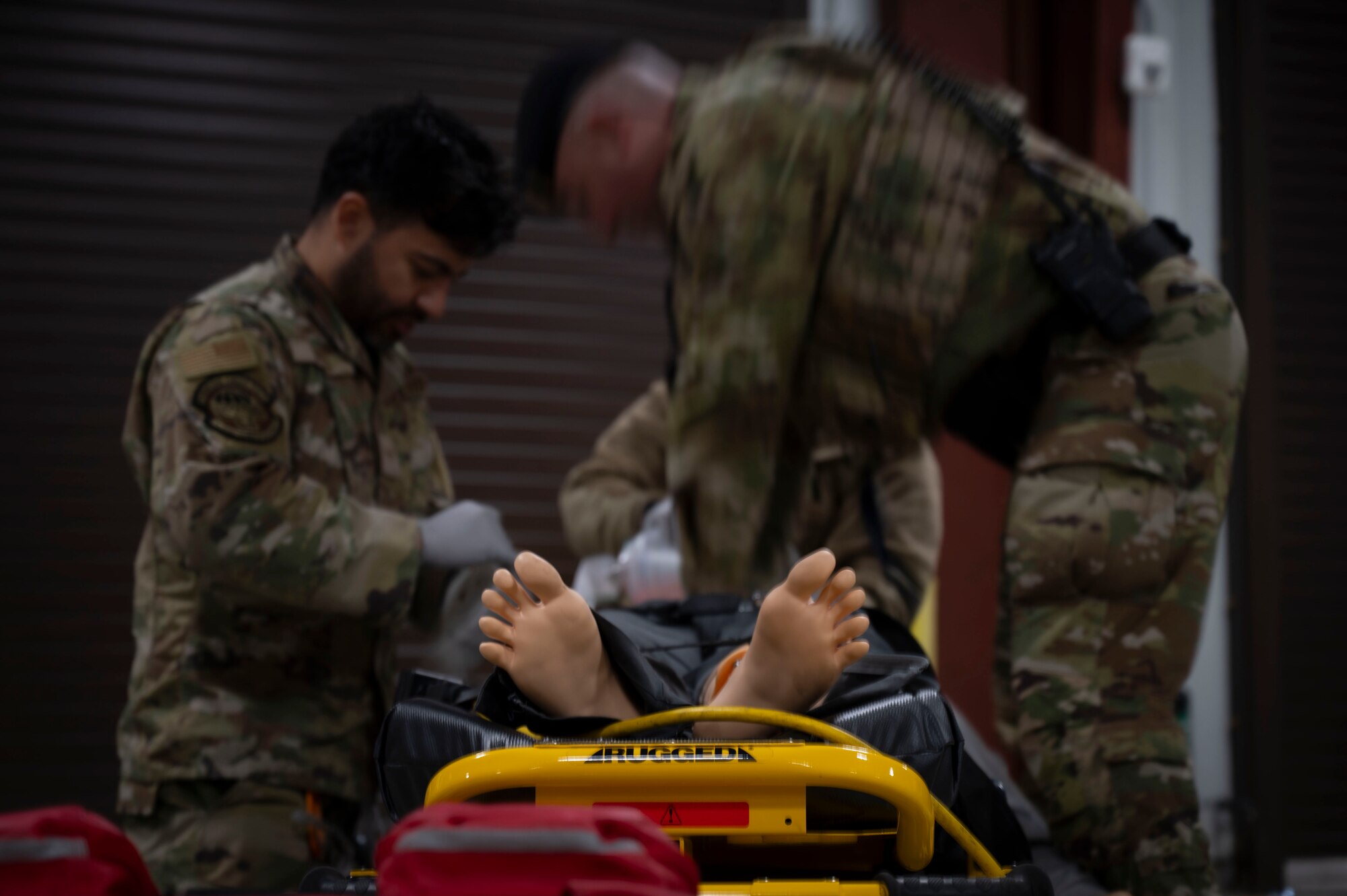 87th Medical Group and 87th Security Forces Squadron members perform CPR on a mannequin that posing as a victim of electric shock during Operation Honey Badger (OHB) at Joint Base McGuire-Dix-Lakehurst, N.J. April 9, 2025. OHB is an exercise organized by the 87th Civil Engineer Squadron to prepare Airmen for real-world situations and promote mission readiness. (U.S. Air Force photo by Airman 1st Class Luisa E. Dugan)