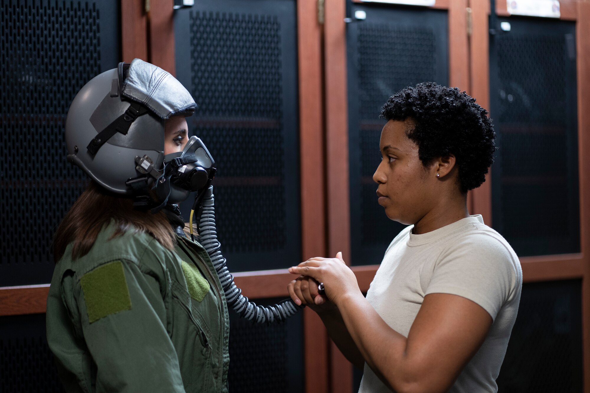 A 1st Operational Support Squadron Aircrew Flight Equipment Airmen helps prepare local news reporter, Madeline Schmitt, to fly in a T-38A Talon aircraft for a media flight.