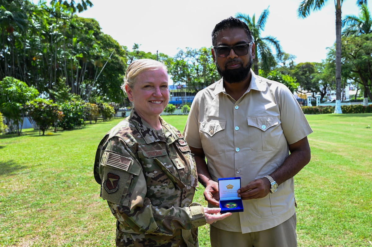 President of Guyana Mohamed Irfaan Ali, and U.S. Air Force Maj. Gen. Melissa A. Coburn, 22nd Air Force commander, poses for a photo after the President of Guyana gifted Coburn with his presidential coin after the closing ceremony for the Lesser Antilles Medical Assistance Team mission at the Guyana President’s estate in Georgetown, Guyana, April 11, 2025.