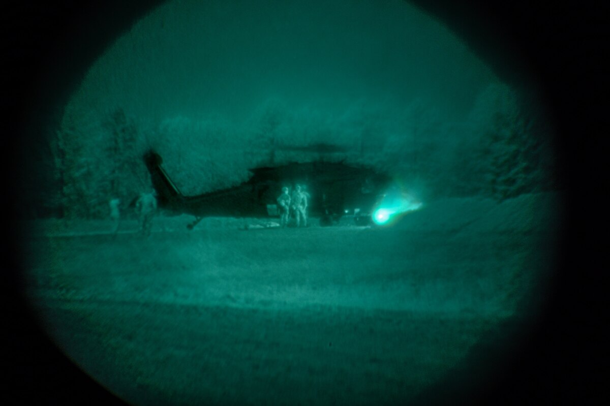 Explosive ordnance disposal (EOD) technicians and 19th Medical Group personnel transport a simulated casualty during a joint EOD field training exercise at Camp Joseph T. Robinson, Arkansas, April 9, 2025. The week-long training emphasized interoperability between EOD technicians and medics, with scenarios that mimicked injuries sustained during combat missions.